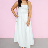 Front view of off white midi dress with brown tie straps and brown tie details around the waist. 