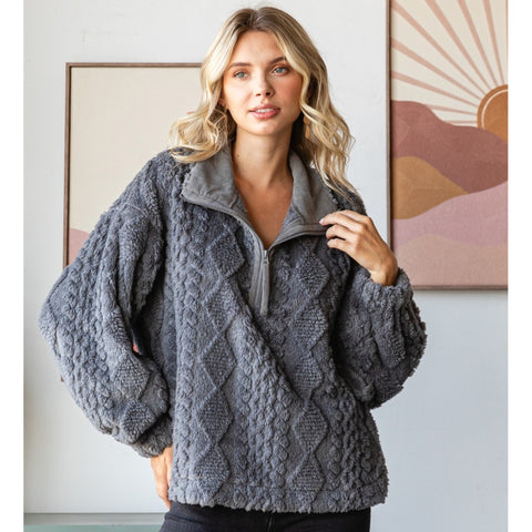 Woman wearing a textured gray sweater