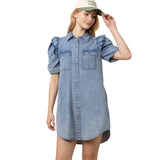 Model wearing the Indigo Denim Button Ruffle Sleeve Dress showing the button front, ruffle sleeves, and flowy silhouette.