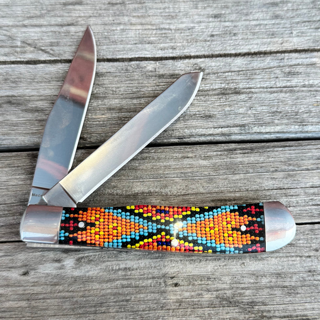 Two blade knife with red, orange, yellow, blue, turquoise and black beaded design.