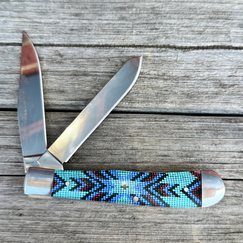 Two blade knife with turquoise beaded design.