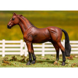 Model horse standing on a grassy field