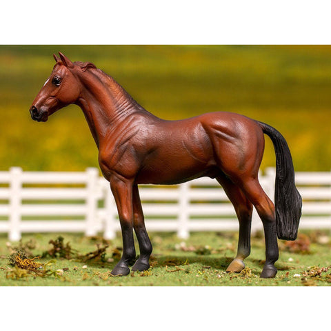 Model horse standing on a grassy field