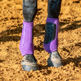 Close up of violet classic fit front boots on a horse standing in the dirt.