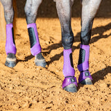 Close up of horse wearing violet classic fit front and back boots and violet bell boots.