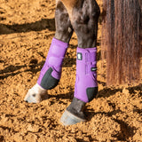 Horses back legs wearing the violet legacy2 support boots.