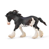 Model horse figurine with black and white coat