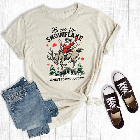 Beige t-shirt with graphic design of Santa on a reindeer