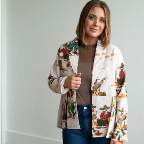 Woman wearing a colorful western scene print blazer