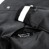 Close up of jacket pocket with the phrase expect the unexpected.