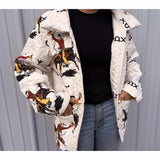 White quilted jacket with colorful designs worn by a person against a gray background
