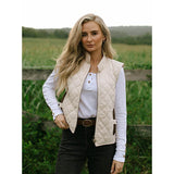 Woman wearing Outback Cream Quilted Riding Vest in rustic outdoor setting"
