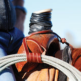 Close up of rope holder in use. Wrapped around rope and saddle horn.
