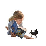 Lifestyle view of child with book and stallion