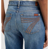 Close‑up of model wearing the 7 For All Mankind Blue Core Bronze Dojo Jean focusing on the denim texture, bronze accents, and pocket detailing.