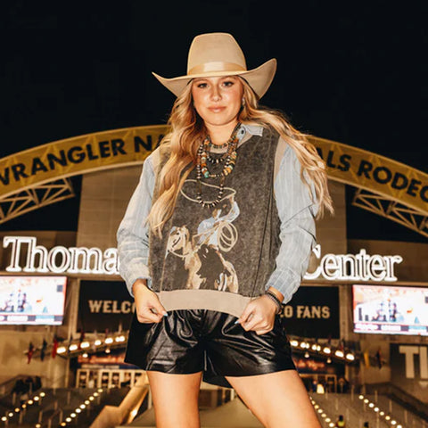 Model wearing the Chocolate Swing Wide Sweater Vest featuring a cowboy swinging a rope