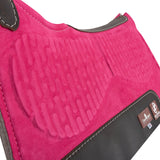 Close up of pink saddle pad with dark brown leather accents.