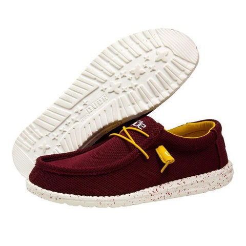 A pair of maroon HEYDUDE shoes on a white background. One of the shoes is positioned where you can see the white bottom.