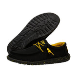 A pair of black HEYDUDE shoes with a yellow insole and laces. One of the shoes is positioned where you can see the bottom side in entirety.