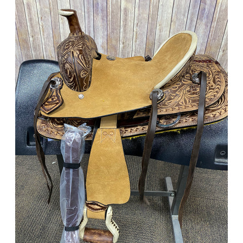 youth saddle with floral tooled background with a tan rawhide seat.