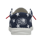 A backside view of a HEYDUDE shoe that is blue with white stars.