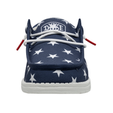 A front view of a HEYDUDE shoe that is blue with white stars. The laces are white.