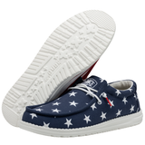 A pair of HEYDUDE shoes that pay tribute to the American flag. One of the shoes is completely visible while the other one is angled to where you can only see the white outsole.
