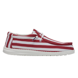 A shoe with red & white stripes (by HEYDUDE) pictured from the side atop a white background.