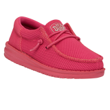 A reddish pink shoe by HEY DUDE. It's pictured from an angle where you can see some of the side and top.