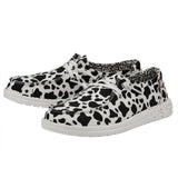 HEYDUDE cow-print shoes with white laces.