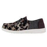A HEYDUDE shoe pictured from the side atop a white background. The pattern is reminiscent of a leopard with neutral patchwork.
